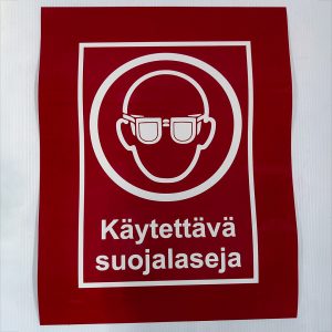 Varoitustarra, käytä suojalaseja